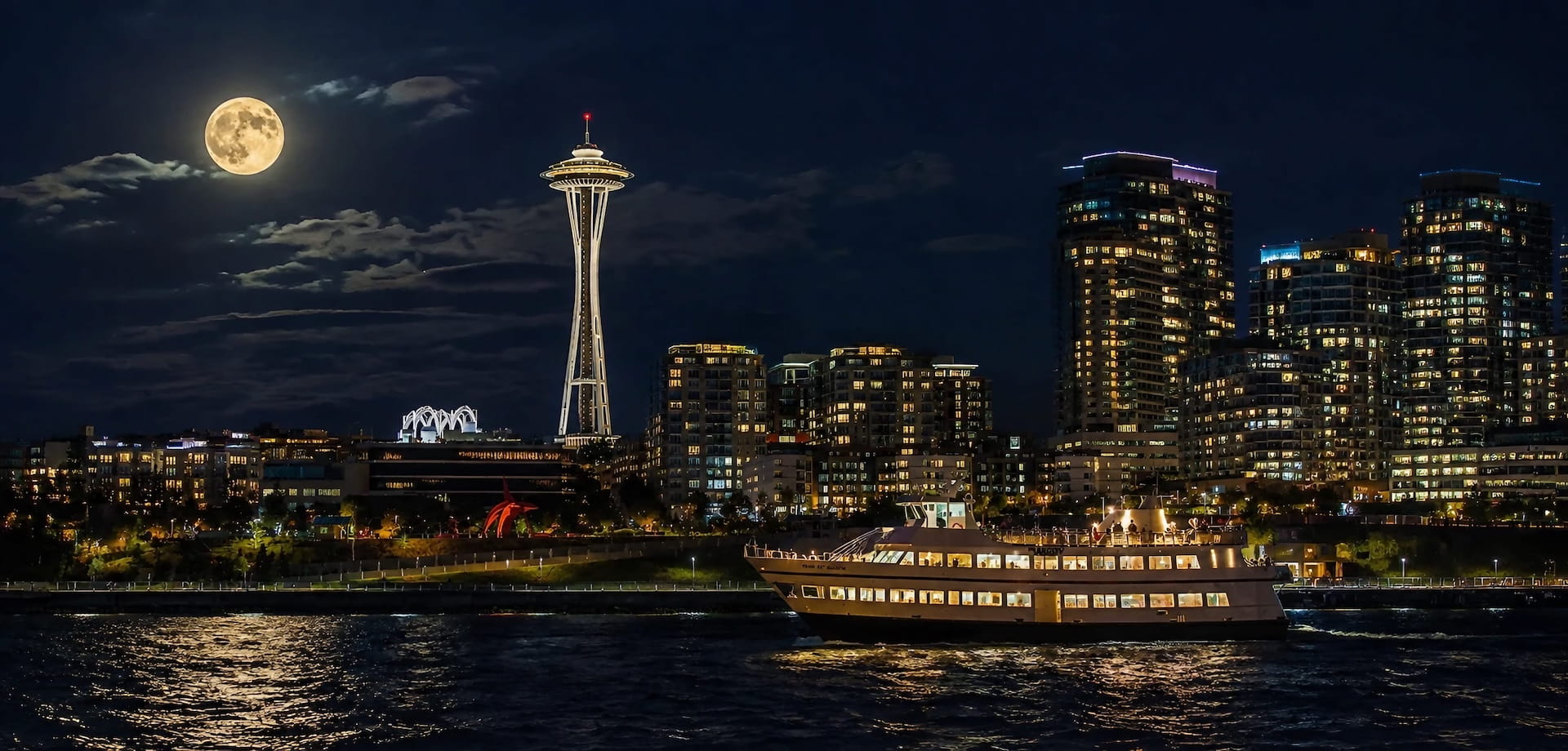 Illuminated dinner boat cruising past the Seattle skyline and Space Needle under a full moon