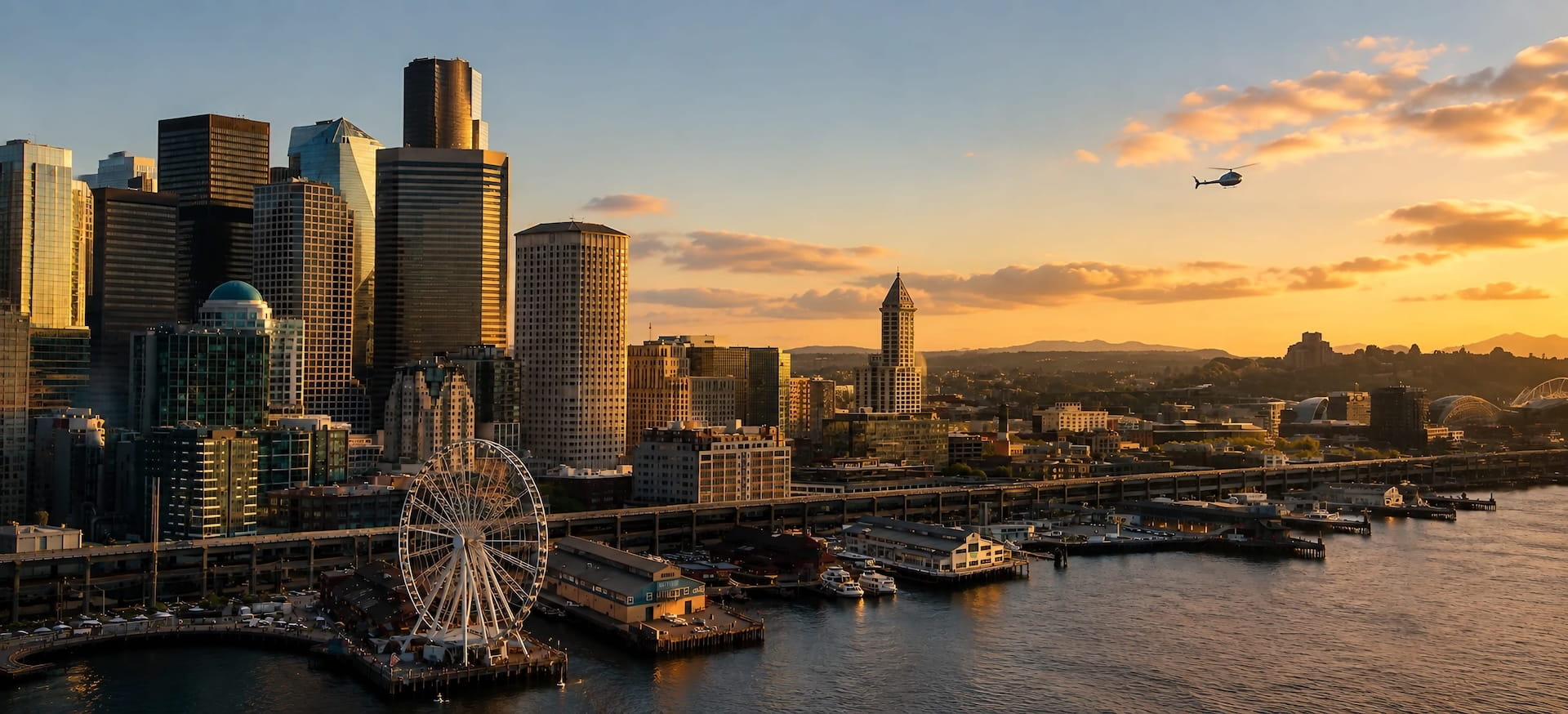 Seattle waterfront piers and the Great Wheel at sunset, seen from a harbour cruise on Elliott Bay