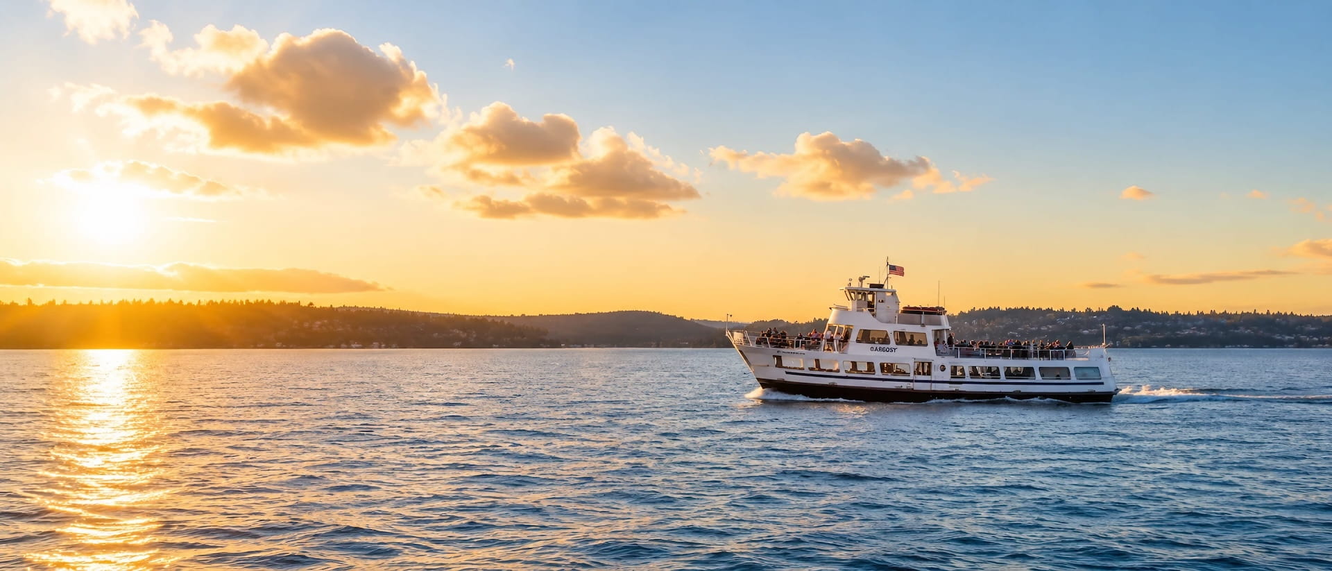 Argosy sightseeing boat cruising Elliott Bay at sunset on a Seattle harbor tour